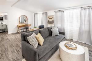 a living room with a gray couch and a table at York Beach Surf Club in York