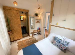 a room with a white bed and a bathroom at Hotel Casa de Verano - Solo adultos - in Santa Fe de Antioquia