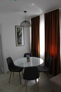 ein Esszimmer mit einem weißen Tisch und Stühlen in der Unterkunft Royal Apartmani in Banja Luka