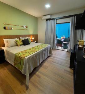 a bedroom with a bed with a view of the ocean at Pousada Júlio Grande in Fernando de Noronha