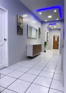 a hallway with a white tiled floor in a building at Hotel KP in Portoviejo