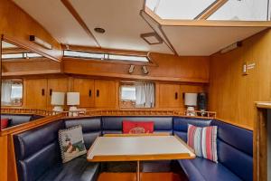 a dining room with a table in a train car at 2BR Spacious & Comfy 43' Yacht - Heat & AC - On the Freedom Trail - Best Nights Sleep in Boston