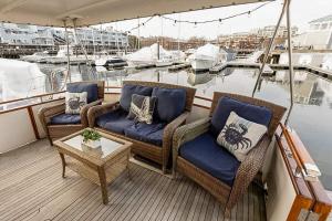 two chairs and a table on the deck of a boat at 2BR Spacious & Comfy 43' Yacht - Heat & AC - On the Freedom Trail - Best Nights Sleep in Boston