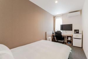 Säng eller sängar i ett rum på HOTEL R9 The Yard Kamisu