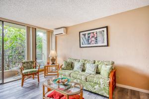 a living room with a couch and a table at Kalanikai #218 in Kailua-Kona