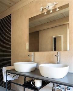 a bathroom with two sinks and a mirror at Hospederia El Batan in Tramacastilla