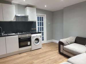 a kitchen with a washing machine and a washer at Lovely 1 bedroom flat High Barnet 3 mins away in Barnet
