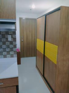 a kitchen with a door with a yellow stripe on it at Grand reviera in the front of famous sunset of manila with stunning beauty of dolomite sand in Manila