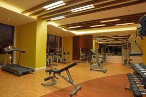 a gym with several exercise equipment in a room at Grand reviera in the front of famous sunset of manila with stunning beauty of dolomite sand in Manila