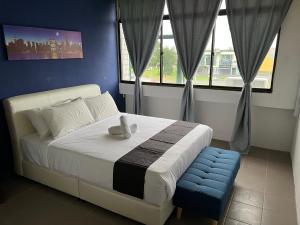 a bedroom with a bed with a teddy bear on it at Cassia Inn Kuching in Kuching