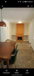 a room with a table and chairs and a fireplace at Casa Blanca in Villa Rumipal