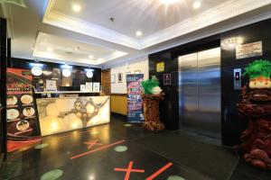 a restaurant lobby with an elevator and an ice cream shop at Coins Hotel Jakarta in Jakarta