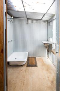 a large bathroom with a tub and a sink at Little Styx River Cabin - The Hilton in Ebor