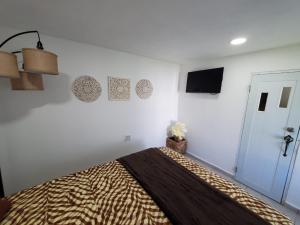 a bedroom with a bed with a blanket on it at Aguadilla Breeze apt in gated complex 8 minute walk to Crashboat beach in Aguadilla