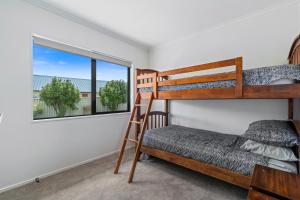 a bedroom with two bunk beds and a window at Cromwell Charmer - Cromwell Holiday Home in Cromwell