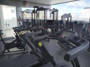 a gym with several treadmills and machines at Espetacular Flat em Miramar 2 in João Pessoa