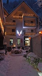 a building with a sign on it in the snow at Borjomi UnderWood in Borjomi