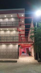 a large building with a red stairway in front of it at Hotel Bello Caribe Express in Cozumel
