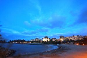 a view of a beach at night with buildings at The Empire Brunei in Bandar Seri Begawan