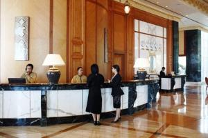 a group of people standing at a bar in a lobby at The Empire Brunei in Bandar Seri Begawan +29 photos