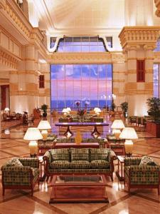 a large lobby with couches and a large window at The Empire Brunei in Bandar Seri Begawan