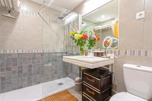 a bathroom with a sink and a toilet and a mirror at Marbella in Love in Marbella