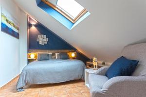 a attic bedroom with a bed and a couch at Marbella in Love in Marbella