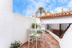 a patio with a table and chairs on a balcony at Marbella in Love in Marbella