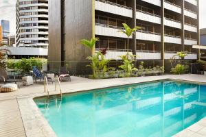 a swimming pool in front of a building at Punthill Spring Hill in Brisbane