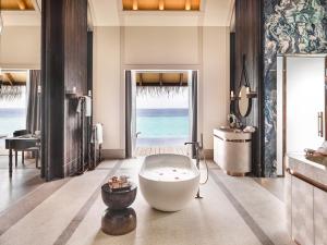 a bathroom with a large tub in the middle of the room at JOALI Maldives in Raa Atoll +37 photos