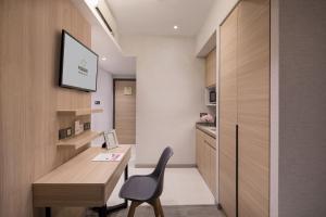 a home office with a desk and a chair at Modena by Fraser Hong Kong in Hong Kong