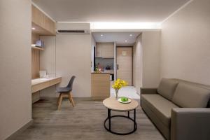 a living room with a couch and a table at Modena by Fraser Hong Kong in Hong Kong