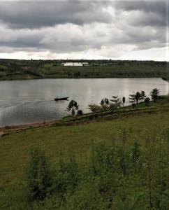 a boat on a lake on a cloudy day at SUGIRA ECO-RESORT in Rwamagana