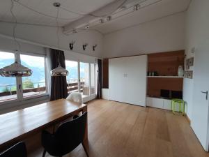 a dining room with a wooden table and chairs at Elfe - Apartments Studio apartment for 2-4 guests with panorama view in Emmetten
