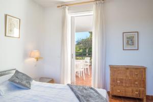 a bedroom with a bed and a door to a patio at Luxury Apartment Los Monteros in Marbella +17 photos