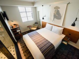 Postel nebo postele na pokoji v ubytování Ebisuholic Hotel