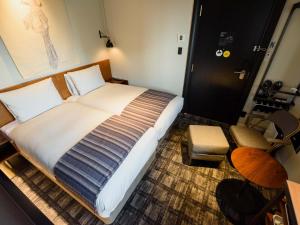 Postel nebo postele na pokoji v ubytování Ebisuholic Hotel