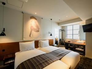Postel nebo postele na pokoji v ubytování Ebisuholic Hotel + 34 fotografií
