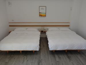 Postel nebo postele na pokoji v ubytování Lanshan Guest House