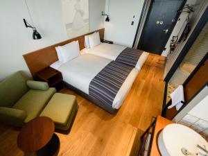 Postel nebo postele na pokoji v ubytování Ebisuholic Hotel