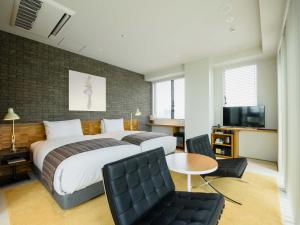 Postel nebo postele na pokoji v ubytování Ebisuholic Hotel