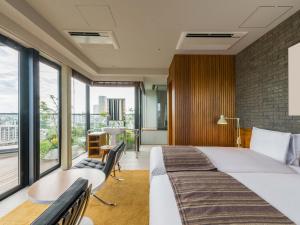 Postel nebo postele na pokoji v ubytování Ebisuholic Hotel