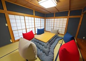 a room with a table and chairs in it at Villa Liberte Hakone Gora in Hakone