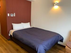 Tempat tidur dalam kamar di Clean Hotels in Higashimachi