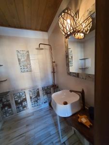 a bathroom with a white sink and a mirror at Rustic Spa at Pirin Golf in Razlog