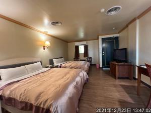 Een bed of bedden in een kamer bij San Ho Business Hotel