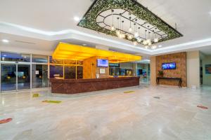 a lobby with a bar in a building at Justiniano Club Park Conti in Okurcalar