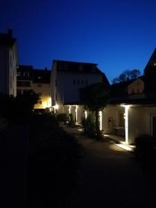 a group of buildings with lights at night at Apartment-EG-04 in Darmstadt