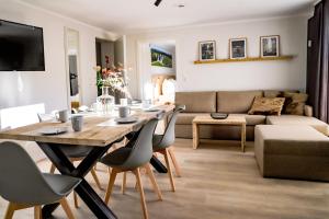 a dining room and living room with a table and chairs at Smart Resorts Haus Saphir Ferienwohnung 502 in Winterberg