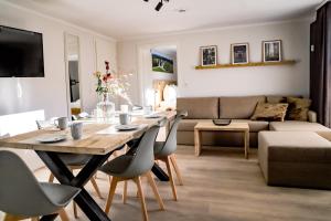 a living room with a table and chairs and a couch at Smart Resorts Haus Saphir Ferienwohnung 502 in Winterberg